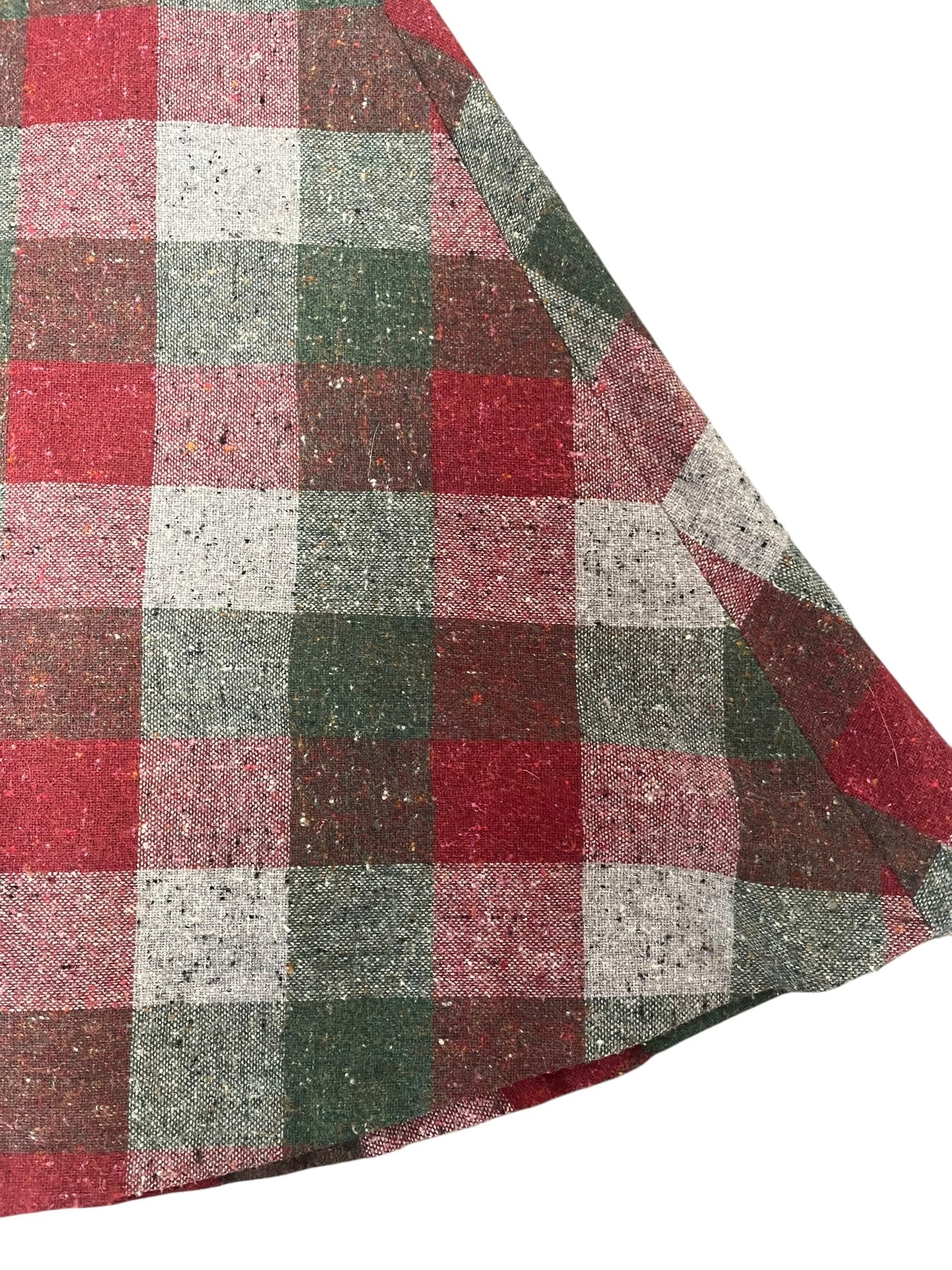 Plaid fabric with red, green, and gray pattern on a white background