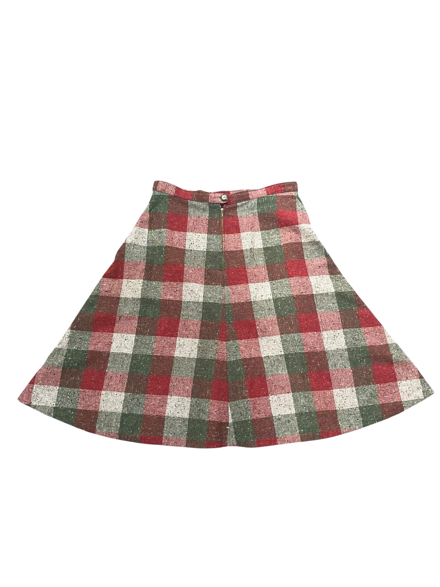 Plaid skirt with red, green, and white pattern on a white background