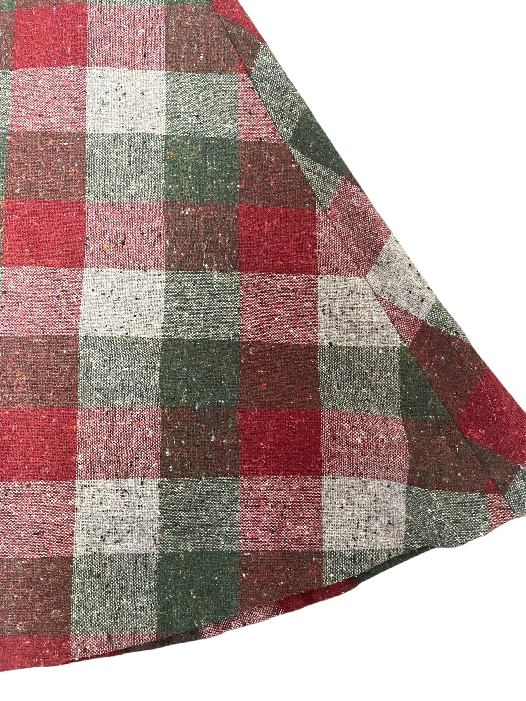 Plaid fabric with red, green, and gray pattern on a white background