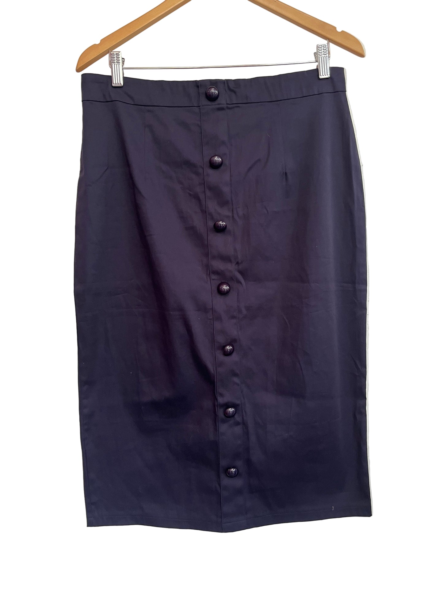 Navy cotton pencil skirt with a split at the back, small pink split at the hem, and zips at the back. Displayed on a hanger.
